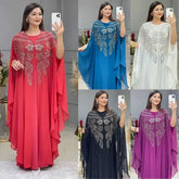 Elegant woman wearing a Plus Size African Dress featuring intricate embroidery, showing the flowing chiffon design in a stylish setting.