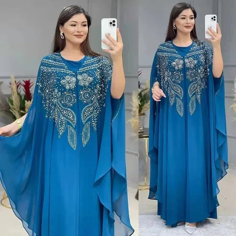 Elegant woman wearing a Plus Size African Dress featuring intricate embroidery, showing the flowing chiffon design in a stylish setting.