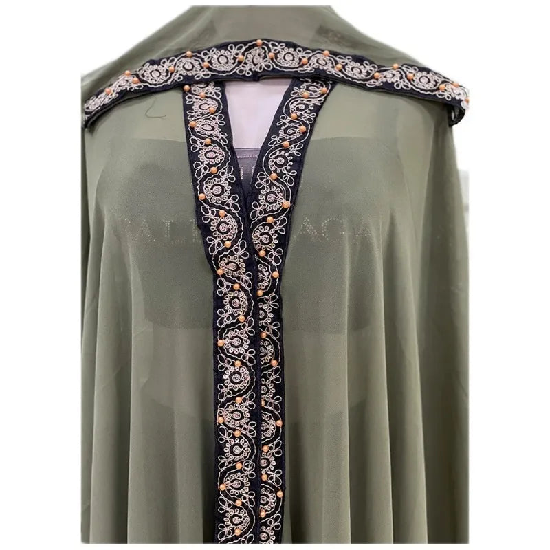 Moroccan Hooded Abaya featuring a stylish design with wide batwing sleeves and a flowing maxi silhouette.