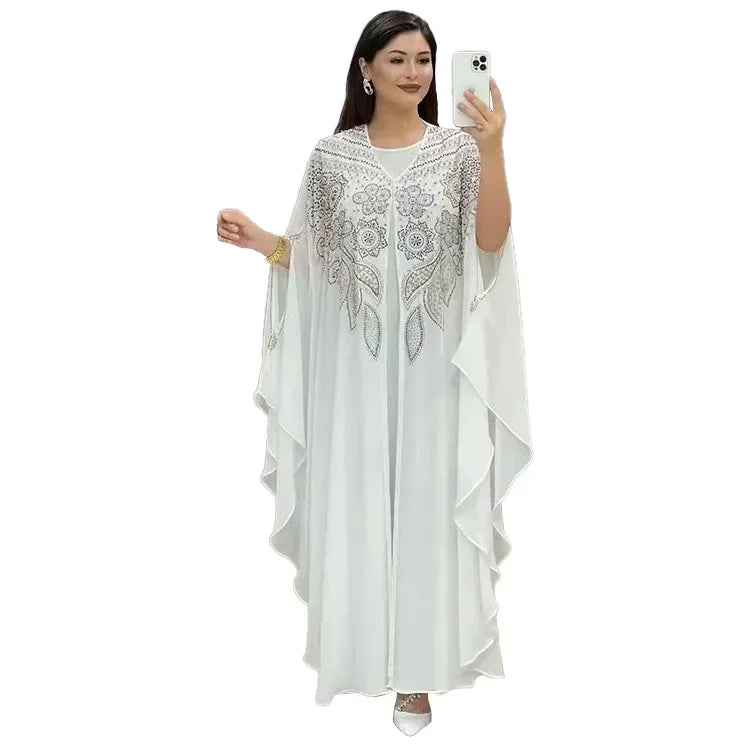 Elegant woman wearing a Plus Size African Dress featuring intricate embroidery, showing the flowing chiffon design in a stylish setting.