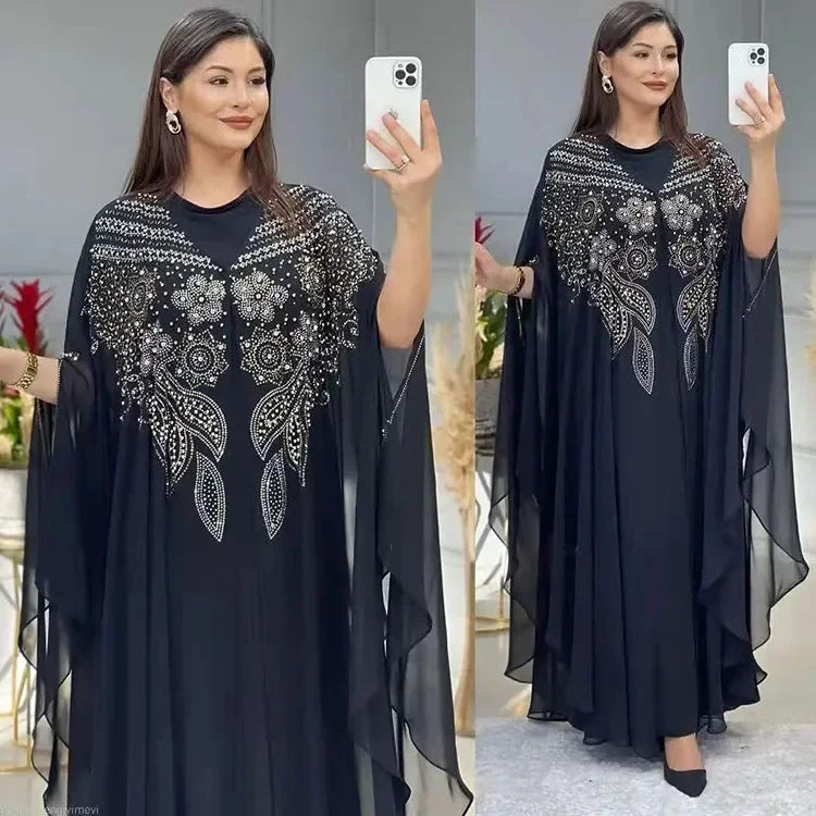 Elegant woman wearing a Plus Size African Dress featuring intricate embroidery, showing the flowing chiffon design in a stylish setting.