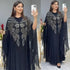 Elegant woman wearing a Plus Size African Dress featuring intricate embroidery, showing the flowing chiffon design in a stylish setting.