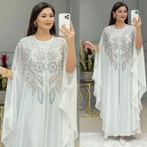 Elegant woman wearing a Plus Size African Dress featuring intricate embroidery, showing the flowing chiffon design in a stylish setting.