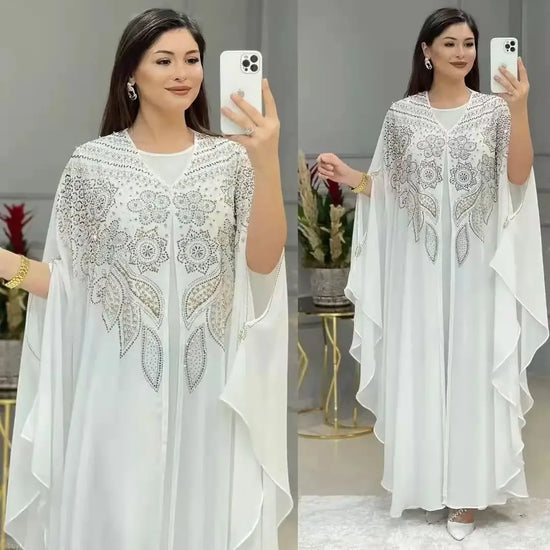 Elegant woman wearing a Plus Size African Dress featuring intricate embroidery, showing the flowing chiffon design in a stylish setting.