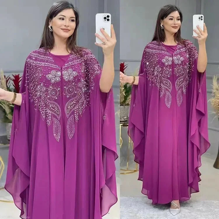 Elegant woman wearing a Plus Size African Dress featuring intricate embroidery, showing the flowing chiffon design in a stylish setting.